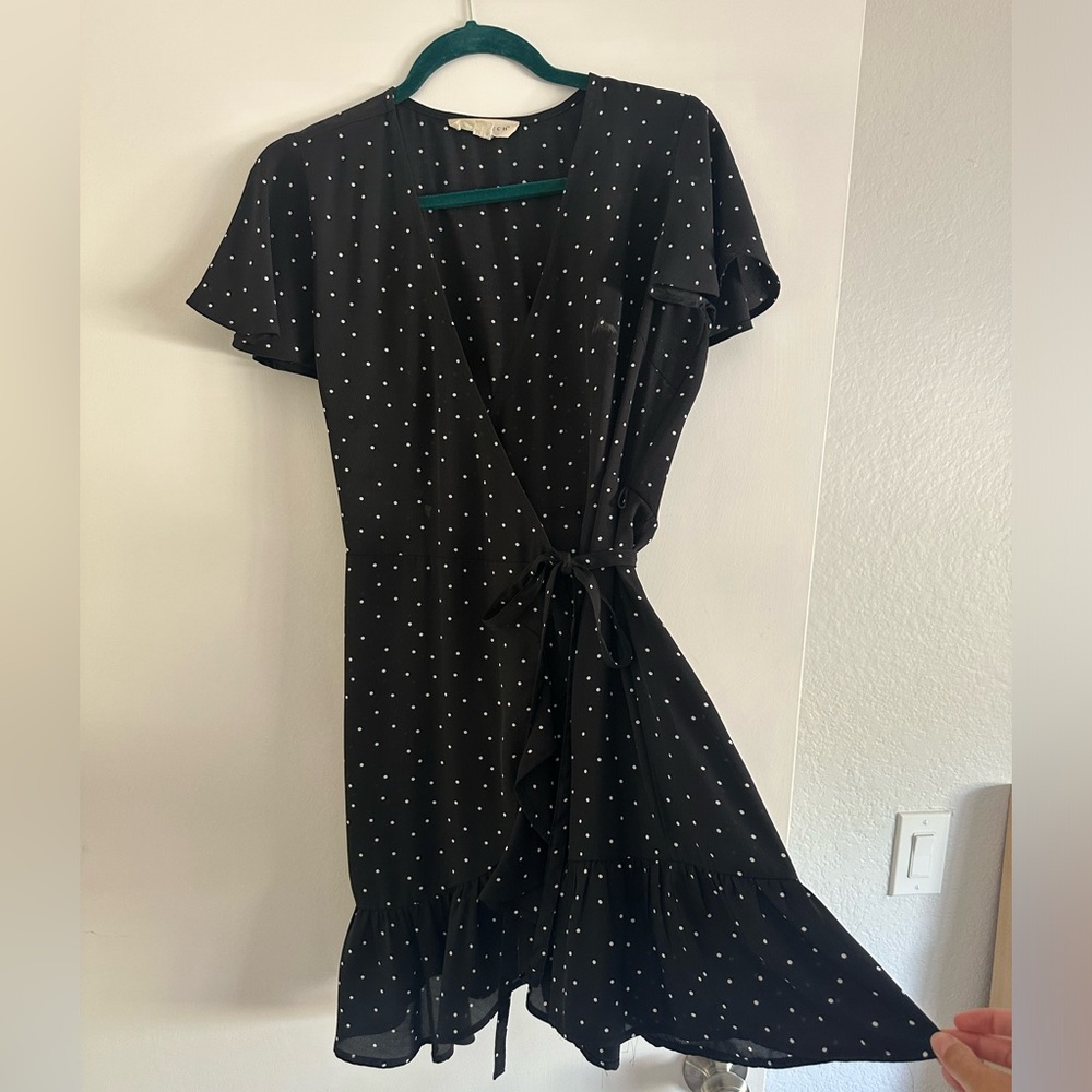Women's black and white mini polka dot wrap dress with tie and ruffles